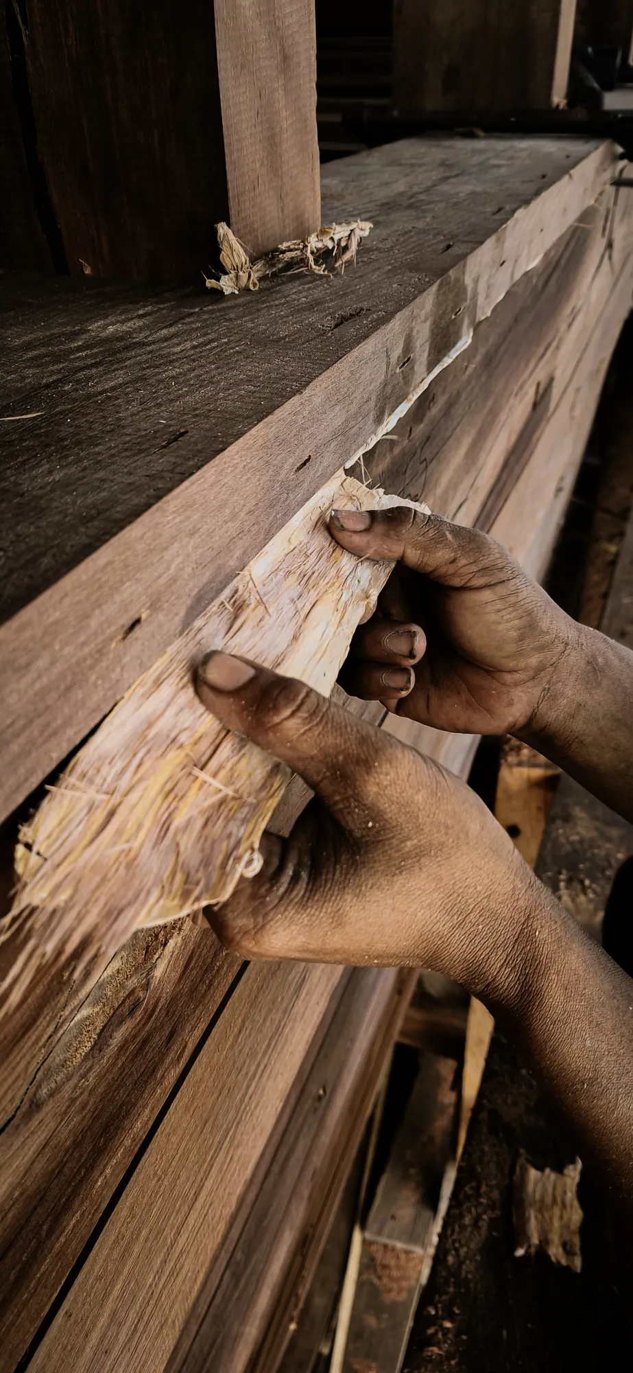 A builder working a plank.