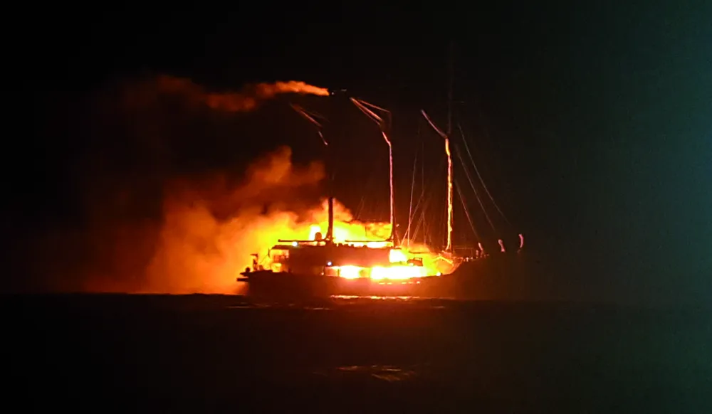 WAOW on fire at night in the port of Biak.