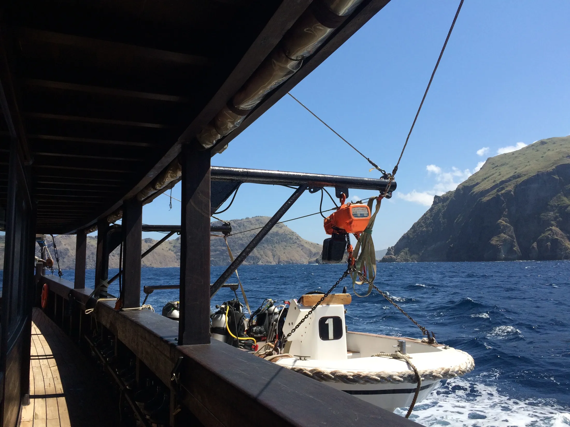 Dive masks and fins racked on Waow 2's dive deck.