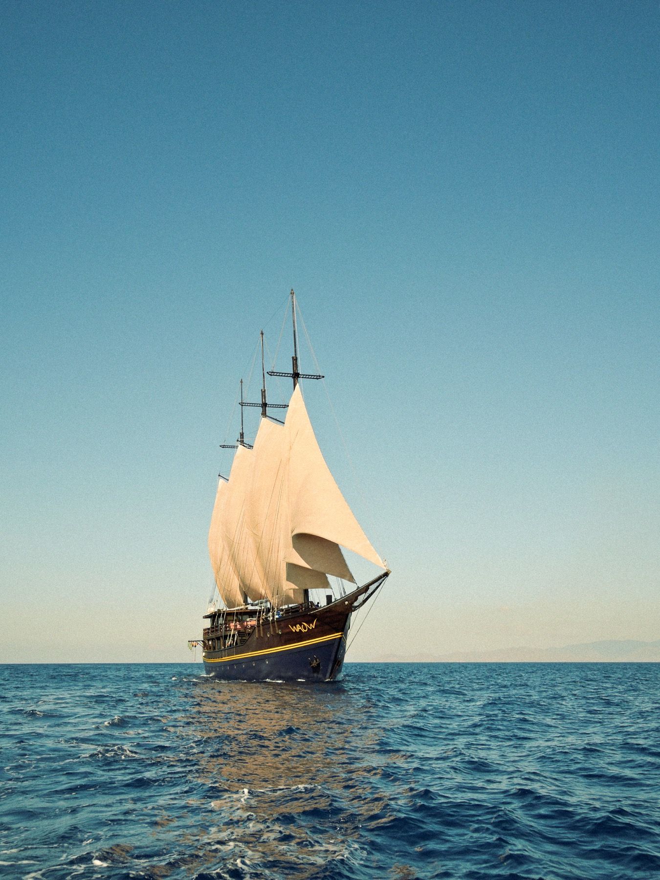 Waow 2 under sail, a different reef waiting at every anchorage.